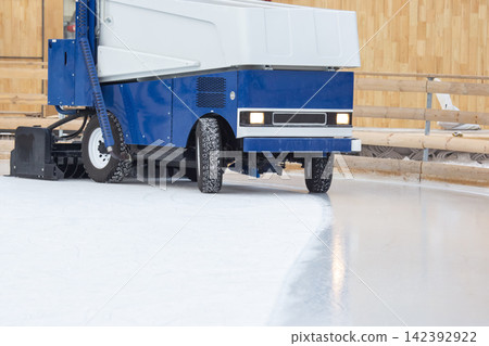 Ice resurfacing machine working on skating rink in winter setting Ice resurfacing machine working on skating rink in winter setting 142392922
