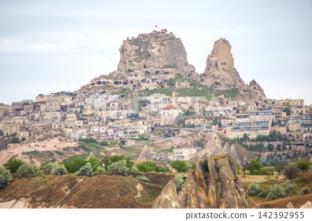 Historic rock formations and cave dwellings in Cappadocia, Turkey create a unique landscape at dusk 142392955