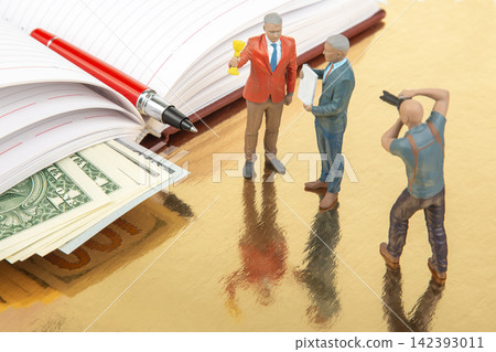 Miniature people having a discussion near a notebook and money on a table Miniature people having a discussion near a notebook and money on a table 142393011