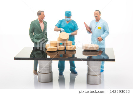 Miniature figures at a table discussing food preparation in a clean, bright kitchen setting Miniature figures at a table discussing food preparation in a clean, bright kitchen setting 142393033