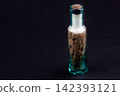 Vintage Glass Bottle with Old Pharmaceutical Tablets on Dark Background 142393121