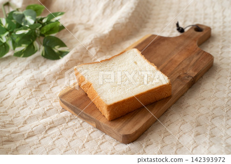 A slice of bread on a cutting board A slice of bread on a cutting board 142393972