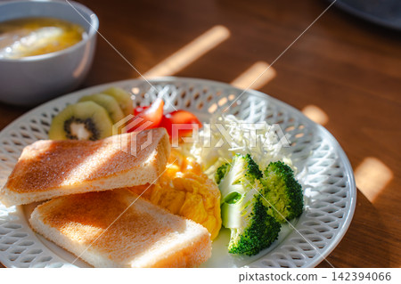 A nutritious breakfast of sun-drenched toast and scrambled eggs. A nutritious breakfast of sun-drenched toast and scrambled eggs. 142394066