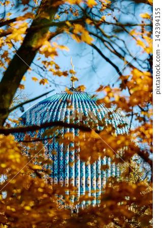 View of Saint Petersburg Blue Mosque through yellow leaves at sunny autumn day, large blue dome, The mosque opened in 1913, was the largest mosque in Europe outside Turkey View of Saint Petersburg Blue Mosque through yellow leaves at sunny autumn day, large blue dome, The mosque opened in 1913, was the largest mosque in Europe outside Turkey 142394155