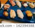 A close-up of Japanese food featuring fresh nigiri sushi. 142394388