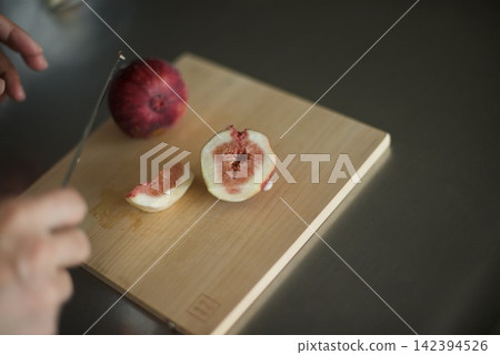 Sliced figs on a cutting board Sliced figs on a cutting board 142394526