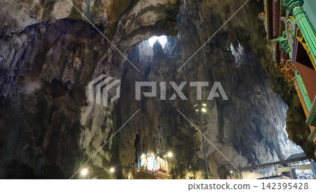 Inside a Cave with Stalactites and a View to the Sky Inside a Cave with Stalactites and a View to the Sky 142395428