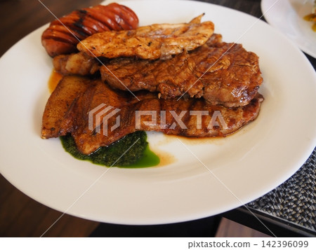 La Paz, Bolivia: A South American-style mixed grill plate featuring juicy meats and sausages. La Paz, Bolivia: A South American-style mixed grill plate featuring juicy meats and sausages. 142396099