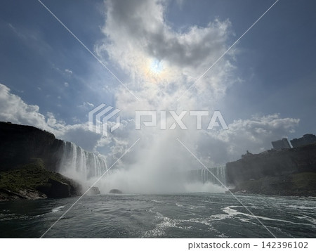 Niagara Falls: A super wide-angle view of the Canadian Falls and the sunlight shining through the mist rising high into the sky. Niagara Falls: A super wide-angle view of the Canadian Falls and the sunlight shining through the mist rising high into the sky. 142396102
