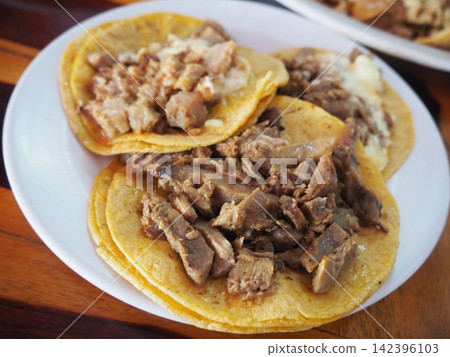 Authentic Mexican cuisine: Tacos piled high with meat and cheese, perfect for enjoying in Cancun. Authentic Mexican cuisine: Tacos piled high with meat and cheese, perfect for enjoying in Cancun. 142396103