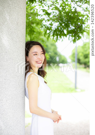 A woman amidst the fresh greenery at a resort/park. A woman amidst the fresh greenery at a resort/park. 142396520