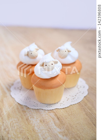 New Year's card featuring a cupcake topped with sheep cream (no text) New Year's card featuring a cupcake topped with sheep cream (no text) 142396808