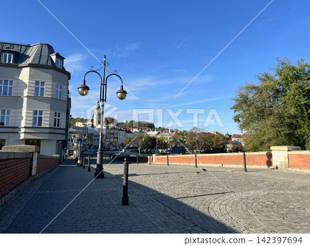Pedestrian bridge with street lamps in Przemysl Poland on a sunny day Pedestrian bridge with street lamps in Przemysl Poland on a sunny day 142397694