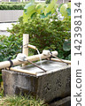 The purification fountain and bamboo ladle at a Shinto shrine: A traditional aspect of Japanese worship culture. 142398134