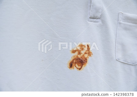 white shirt with stubborn brown sauce stain white shirt with stubborn brown sauce stain 142398378