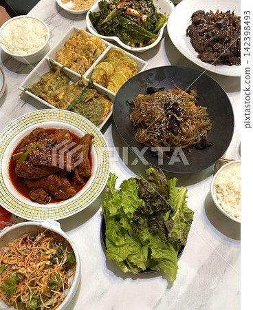 A vibrant spread of Korean food on the table, featuring various banchan (side dishes) like kimchi, pickled vegetables, and seasoned greens. Perfect for food photography, showcasing traditional Korean. A vibrant spread of Korean food on the table, featuring various banchan (side dishes) like kimchi, pickled vegetables, and seasoned greens. Perfect for food photography, showcasing traditional Korean. 142398493
