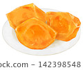 A realistic illustration of a persimmon cut and arranged on a plate. 142398548