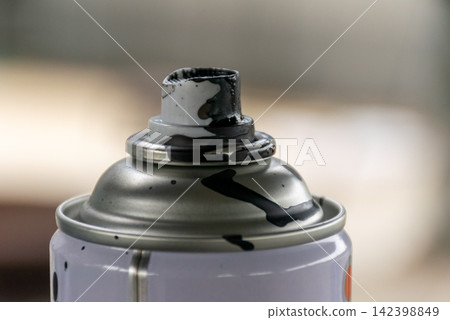 Close up of spray can nozzle stained black paint showing metal container details paint residue for coating repair craft maintenance themes 142398849