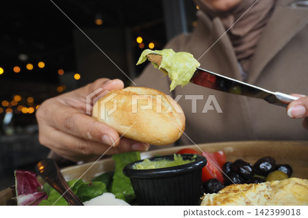 Enjoying food at a restaurant in the evening Enjoying food at a restaurant in the evening 142399018
