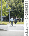 Children in school bags crossing a pedestrian crossing on their way to school. 142399234