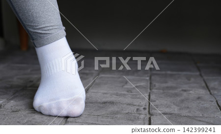 A woman with a leg ache, she is running in the park. A woman with a leg ache, she is running in the park. 142399241