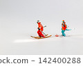 Miniature Figurines of Skiers on White Background 142400288