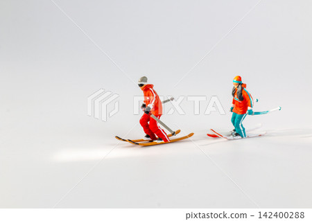 Miniature Figurines of Skiers on White Background Miniature Figurines of Skiers on White Background 142400288