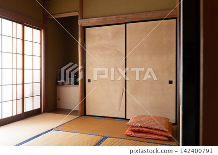 一間建於昭和時代中期、隨著時間推移而破敗的日式房間,一棟獨立式住宅裡的老式滑動門和靠墊,以及我父母家的壁櫥。 一間建於昭和時代中期、隨著時間推移而破敗的日式房間,一棟獨立式住宅裡的老式滑動門和靠墊,以及我父母家的壁櫥。 142400791