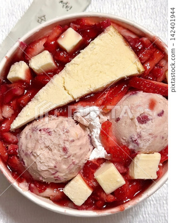 Soft and fluffy strawberry bingsu with finely shaved ice, sweet strawberry syrup, and fresh strawberry slices. A refreshing and delightful Korean dessert, perfect for a cool and fruity treat. Soft and fluffy strawberry bingsu with finely shaved ice, sweet strawberry syrup, and fresh strawberry slices. A refreshing and delightful Korean dessert, perfect for a cool and fruity treat. 142401944