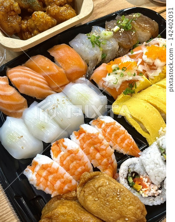 An assortment of fresh sushi, artfully arranged with a variety of toppings and vibrant colors. This traditional Japanese dish combines vinegared rice, seafood, and vegetables for an experience. An assortment of fresh sushi, artfully arranged with a variety of toppings and vibrant colors. This traditional Japanese dish combines vinegared rice, seafood, and vegetables for an experience. 142402031