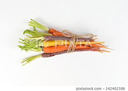 Colorful fresh carrots and radishes tied with string Colorful fresh carrots and radishes tied with string 142402386