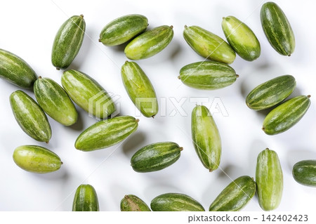 Close-up of fresh green sunflower seeds on white background Close-up of fresh green sunflower seeds on white background 142402423