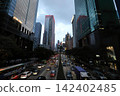 City street view with tall skyscrapers and busy traffic 142402485