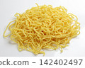 Close-up of a nest of raw yellow noodles on white background 142402497
