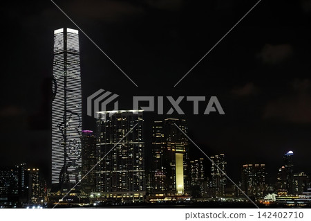 Night cityscape with tall skyscrapers and bright lights Night cityscape with tall skyscrapers and bright lights 142402710