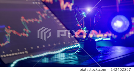 Business success concept with a champion trophy on a laptop keyboard against glowing financial stock market charts. Business success concept with a champion trophy on a laptop keyboard against glowing financial stock market charts. 142402897