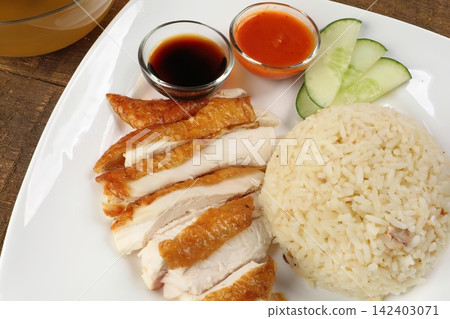 Sliced chicken breast with cucumber and sauce on white plate Sliced chicken breast with cucumber and sauce on white plate 142403071