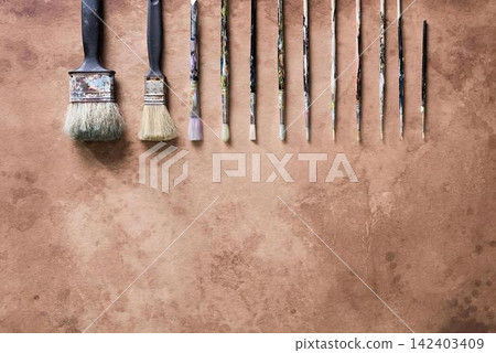 Set of makeup brushes and tools on brown wooden surface Set of makeup brushes and tools on brown wooden surface 142403409