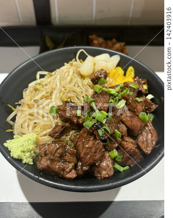 Juicy sliced steak served over warm rice in a hearty bowl, offering tender texture and rich savory flavor. Simple, satisfying, and visually appealing, perfect for modern comfort food visuals. Juicy sliced steak served over warm rice in a hearty bowl, offering tender texture and rich savory flavor. Simple, satisfying, and visually appealing, perfect for modern comfort food visuals. 142403916