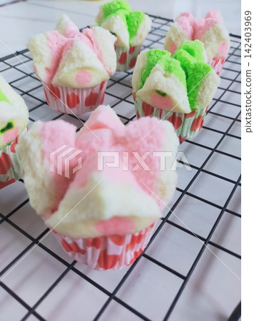 Bolu kukus mekar or Blooming steamed sponge is a children's favorite snack made from flour, sugar, eggs and then steamed, it tastes sweet and soft Bolu kukus mekar or Blooming steamed sponge is a children's favorite snack made from flour, sugar, eggs and then steamed, it tastes sweet and soft 142403969