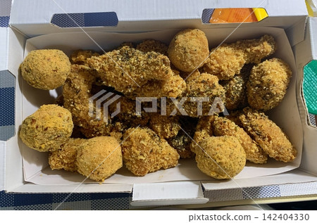 Crispy Korean fried chicken, perfectly glazed with a sweet and spicy sauce. Ideal for food photography and menus, showcasing the irresistible crunch and flavor of this beloved dish. 142404330