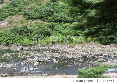 The fresh green scenery of Hozukyo Gorge as seen from the Kyoto Sagano Scenic Railway. The fresh green scenery of Hozukyo Gorge as seen from the Kyoto Sagano Scenic Railway. 142405761