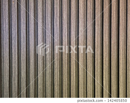 Modern vertical fluted wall panel texture with dark brown wood grain finish. Architectural interior design background featuring rhythmic linear patterns and ribbed surface for home decor. Modern vertical fluted wall panel texture with dark brown wood grain finish. Architectural interior design background featuring rhythmic linear patterns and ribbed surface for home decor. 142405850