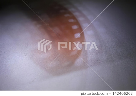 Close-up of film reel with orange and white colors 142406202