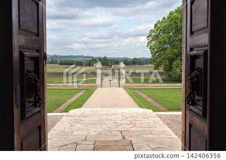 Courtyard and park seen from the entrance of a castle Courtyard and park seen from the entrance of a castle 142406356