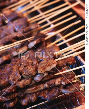 Wagyu beef skewers grilling on hot teppanyaki teppan iron plate, premium Japanese marbled meat on wooden sticks, traditional street food festival, Tokyo, Japan, market with local vendor stalls cooking Wagyu beef skewers grilling on hot teppanyaki teppan iron plate, premium Japanese marbled meat on wooden sticks, traditional street food festival, Tokyo, Japan, market with local vendor stalls cooking 142406493