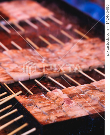 Wagyu beef skewers grilling on hot teppanyaki teppan iron plate, premium Japanese marbled meat on wooden sticks, traditional street food festival, Tokyo, Japan, market with local vendor stalls cooking Wagyu beef skewers grilling on hot teppanyaki teppan iron plate, premium Japanese marbled meat on wooden sticks, traditional street food festival, Tokyo, Japan, market with local vendor stalls cooking 142406496