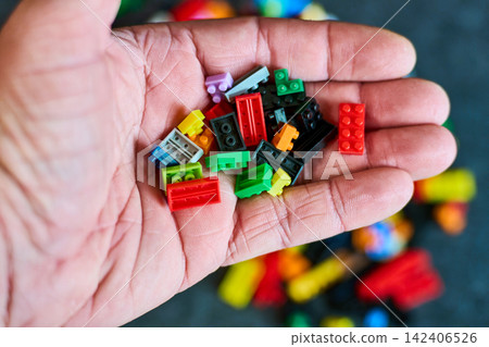 Colorful Building Blocks in Hand - Creative Play Concept Colorful Building Blocks in Hand - Creative Play Concept 142406526