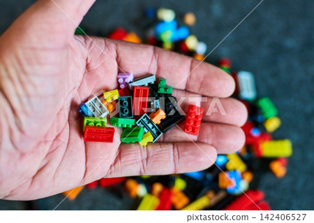 Hand Holding Colorful Building Blocks Hand Holding Colorful Building Blocks 142406527