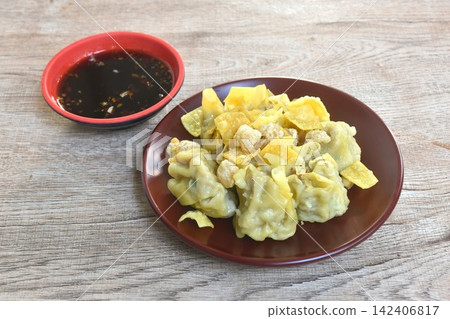 steamed yellow Chinese dumpling filling mashed pork or dim sum topping crispy cracker on plate dipping sour soy sauce steamed yellow Chinese dumpling filling mashed pork or dim sum topping crispy cracker on plate dipping sour soy sauce 142406817